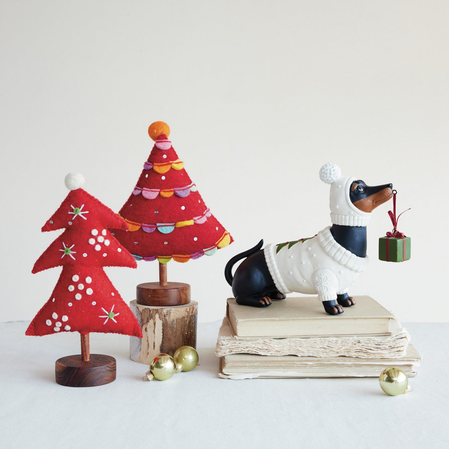 Resin Dachshund in Holiday Sweater Holding Present