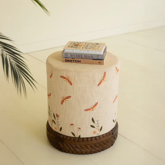 Cream Upholstered Ottoman with Embroidered Detail and Carved Wood Base