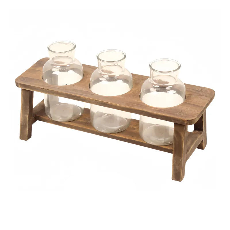 Wooden shelf with three glass jars on a white background